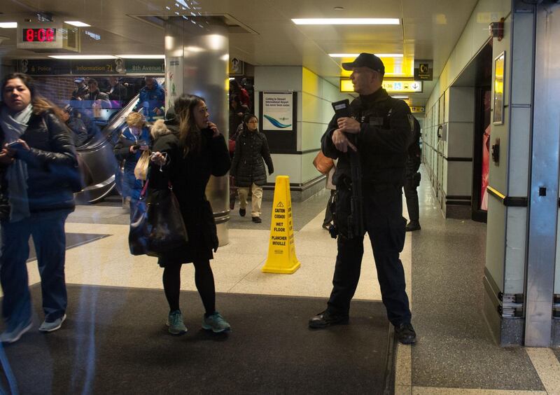 Port Authority Police watch as people evacuate after a reported explosion at the Port Authority Bus Terminal on December 11, 2017 in New York. Bryan Smith / AFP