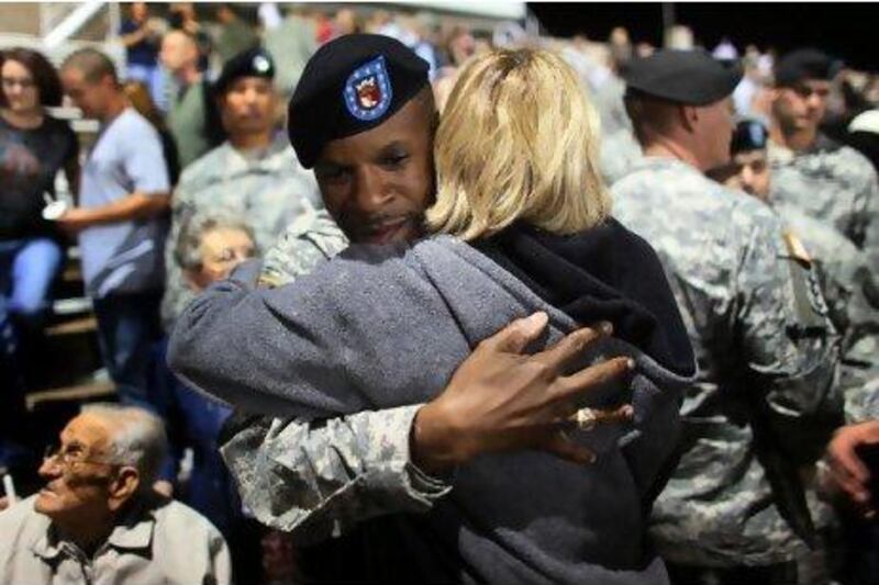 Stunned servicemen and families gather in November 2009 after Maj Nidal Hasan, a US army psychiatrist, kills 13 people in a shooting rampage at 
Fort Hood, Texas. He was arraigned for trial this July. Joe Raedle / Getty Images / AFP