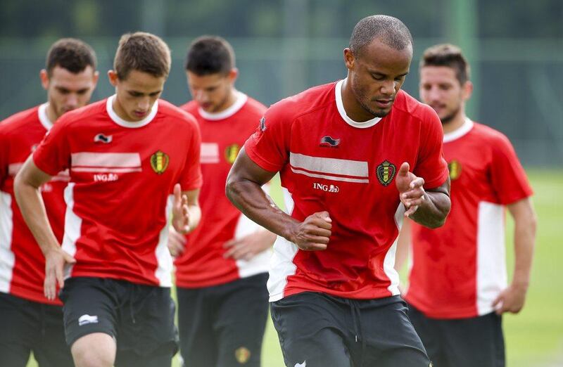 Vincent Kompany leads a run at Belgium'straining session on Saturday as they prepare for their 2014 World Cup Group H opener on Tuesday. Diego Azubel / EPA / June 14, 2014 
