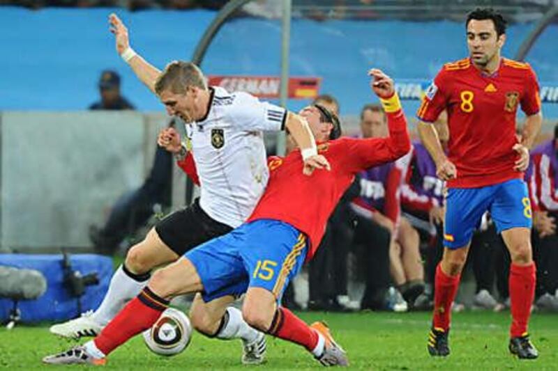 Bastian Schweinsteiger, left, the Germany midfielder, is challenged by Sergio Ramos, the Spain right-back.