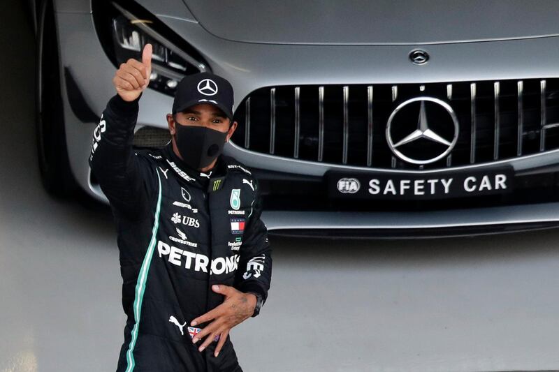 Mercedes' British driver Lewis Hamilton gestures after taking the pole position after the qualifying session for the Formula One Russian Grand Prix at the Sochi Autodrom Circuit in Sochi on September 26, 2020. / AFP / POOL / Pavel Golovkin
