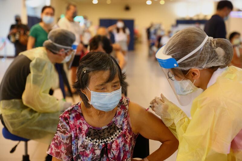 A medical worker gives a dose of the AstraZeneca coronavirus vaccine to a woman during a vaccination session for people over 75 years of age at a stadium in New Taipei City, Taiwan. Reuters