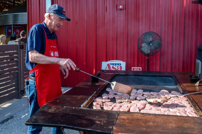 Former Arkansas governor Asa Hutchinson flips meat at the fair's grill. Bloomberg