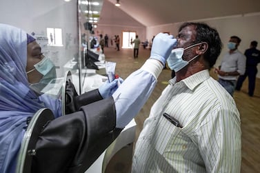 A worker undergoes a Covid-19 screening in Abu Dhabi. Victor Besa/The National 
