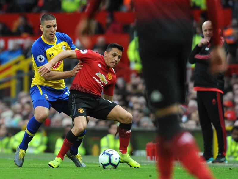 Southampton's Oriol Romeu, left, and Manchester United's Alexis Sanchez duel for the ball. EPA