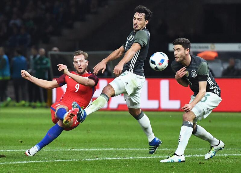 Harry Kane (L) of England shoots at goal while Mats Hummels (C) and Jonas Hector (R) of Germany try to block during the International Friendly match between Germany and England at Olympiastadion on March 26, 2016 in Berlin, Germany.  (Photo by Matthias Hangst/Bongarts/Getty Images)