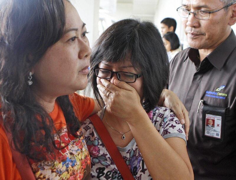 A relative of AirAsia flight QZ8501 passengers weeps as she waits for the latest news on the missing jetliner at Juanda International Airport in Surabaya, East Java, Indonesia. A massive sea search was underway for the AirAsia plane that disappeared Sunday while flying from Indonesia to Singapore through airspace possibly thick with dense storm clouds, strong winds and lightning, officials said. Trisnadi / AP

