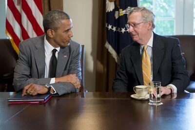 U.S. President Barack Obama, left, talks to Senate Minority Leader Mitch McConnell, a Republican from Kentucky, during a meeting with members of Congress on foreign policy in Cabinet Room of the White House in Washington, D.C., U.S., on Thursday, July 31, 2014. The U.S. might move to limit derivatives trading and short-term loans with Russian companies if sanctions already imposed fail to sway President Vladimir Putin to end support for rebels in eastern Ukraine. Photographer: Andrew Harrer/Bloomberg *** Local Caption *** Barack Obama; Mitch McConnell