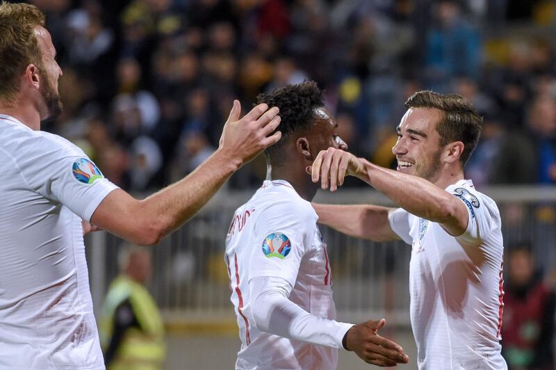 England's Harry Winks celebrates with teammates after scoring. AFP