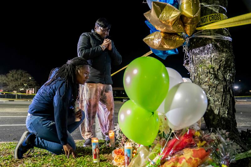 Lashana Hicks joins other mourners at a memorial for those killed in a fatal shooting. Getty Images / AFP