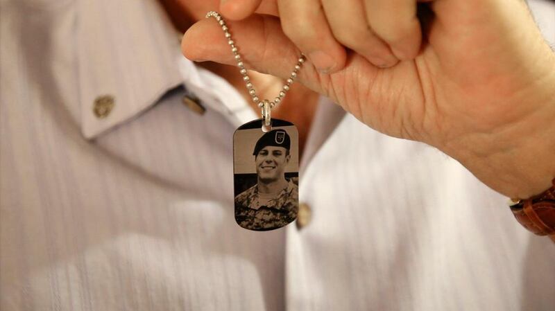 Brian McEnroe, the father of fallen US Green Beret Kevin McEnroe, displays a memorial dog tag depicting his fallen son, in Amman, Jordan. AP / Sam McNeil