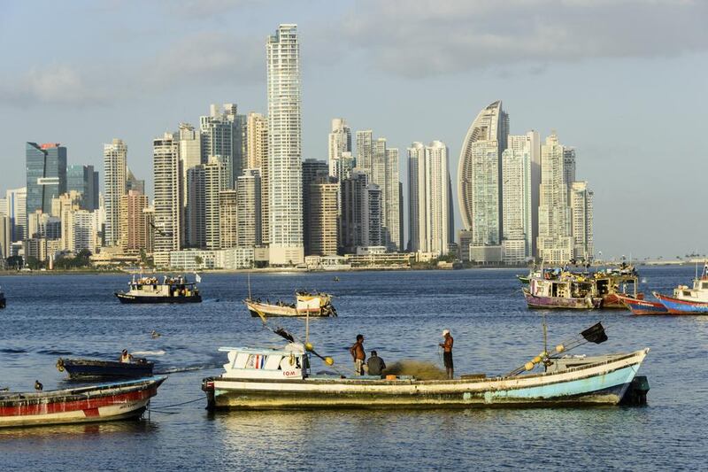 Fishermen preparing their nets on a boat with Panama City in the background.  Emirates was due to start flying to Panama from March 31. Oscar Gutierrez / istockphoto.com