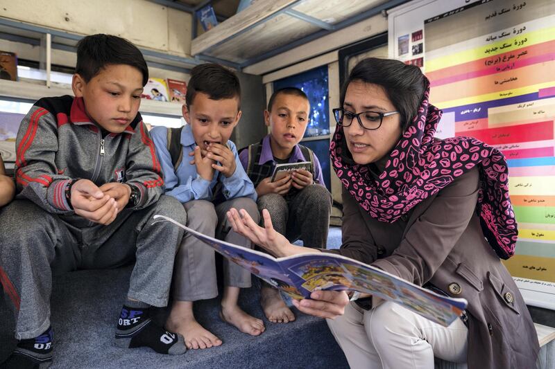 Freshta Karim reading to a group of boys on the bus. Kern Hendricks for The National