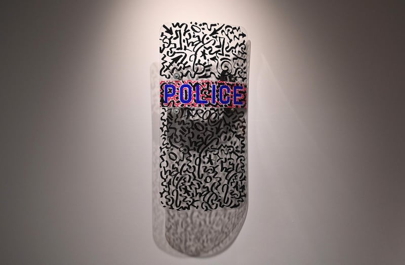 A police shield by artist LA2/LAROC (Angel Ortiz) is displayed during a press preview at Sotheby's Hip-Hop acution. AFP