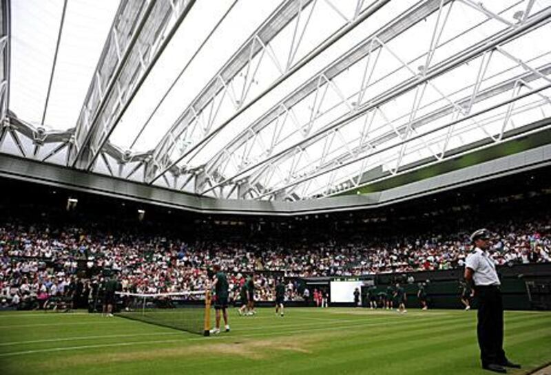 The roof is closed over Centre Court as rain stops play during the match between Amelie Mauresmo of France and Russia's Dinara Safina today.