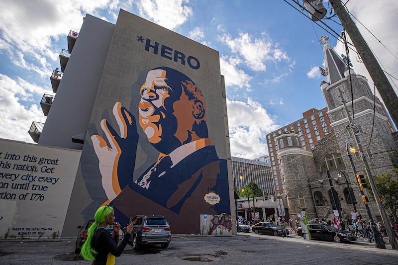 Black Lives Matter demonstrators march past a mural of civil right leader and US Representative John Lewis in the wake of the Atlanta Police deadly shooting of Rayshard Brooks in Atlanta, Georgia, USA.  EPA