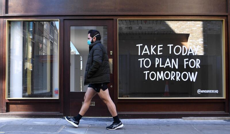 A man walks past a closed down shop in London, Britain. EPA