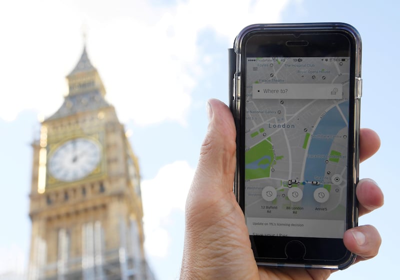 FILE PHOTO: A photo illustration shows the Uber app on a mobile telephone, as it is held up for a posed photograph in central London, Britain September 22, 2017. REUTERS/Toby Melville/File Photo