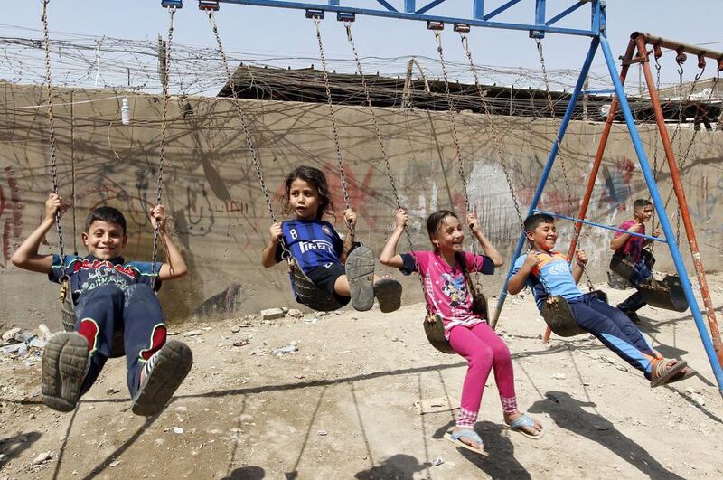Iraqi children play on a street in the capital Baghdad during the Eid al-Adha holiday. AFP
