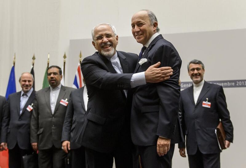 Iranian foreign minister Mohammad Javad Zarif (left) and French foreign minister Laurent Fabius after making a statement about the landmark nuclear agreement in Geneva. Fabrice Coffrini / AFP