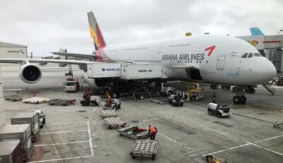 An Asiana Airlines Airbus A380 airplane sits at a gate at Los Angeles International Airport on May 24, 2018. (Photo by Daniel SLIM / AFP)
