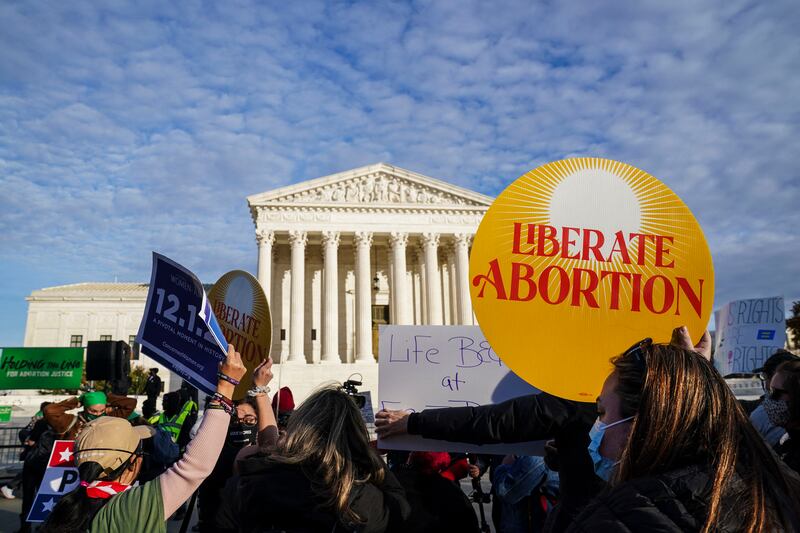 People hold signs during the Women's March 'Hold The Line For Abortion Justice' at the US Supreme Court in Washington. AFP
