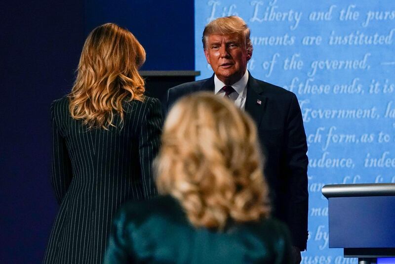 President Donald Trump watches as first lady Melania Trump arrives on stage followed by Jill Biden, wife of Democratic presidential candidate former Vice President Joe Biden. AP Photo