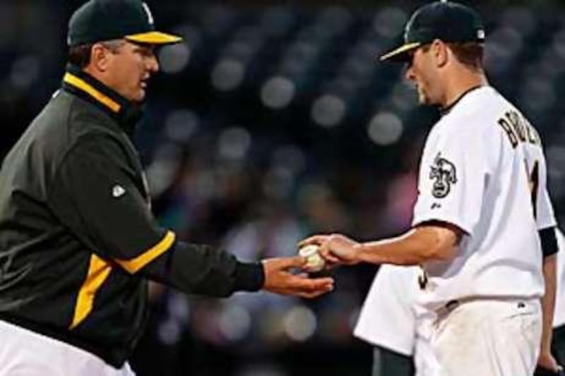 The Oakland pitcher Dallas Bredan, right, with Bob Geren, the manager of the A's.