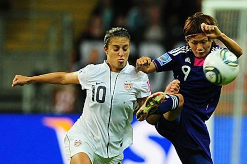 USA's Carli Lloyd, left, and Japan's midfielder Nahomi Kawasumi battle for the ball during the final. Japan won 3-1 on penalties after the final finished 2-2 after extra time.