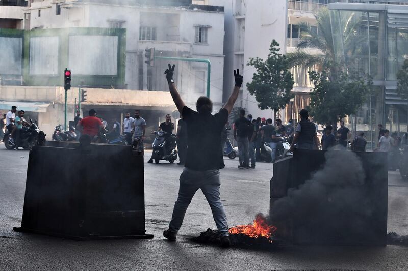 Anti-Government protestors set garbage bins on fire and block the majority of the main roads. EPA