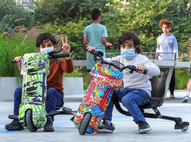 Abu Dhabi, United Arab Emirates, January 21, 2021.  Abdulaziz, 7, and brother Mohammed, 4, ride their bikes around the ping pong area in Al Fay Park on Reem Island.
Victor Besa/The National 
Section:  LF
Reporter: Panna Munyal
