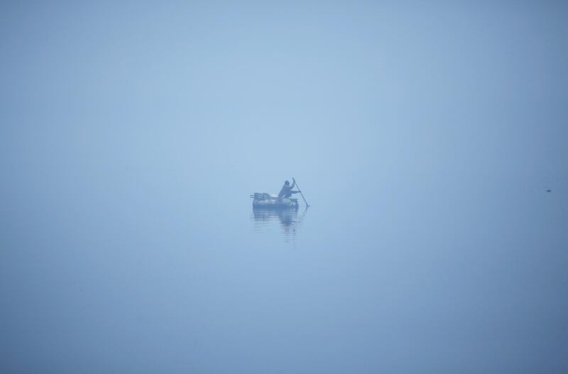 A man paddles across the Yamuna river in New Delhi, India. Adnan Abidi / Reuters