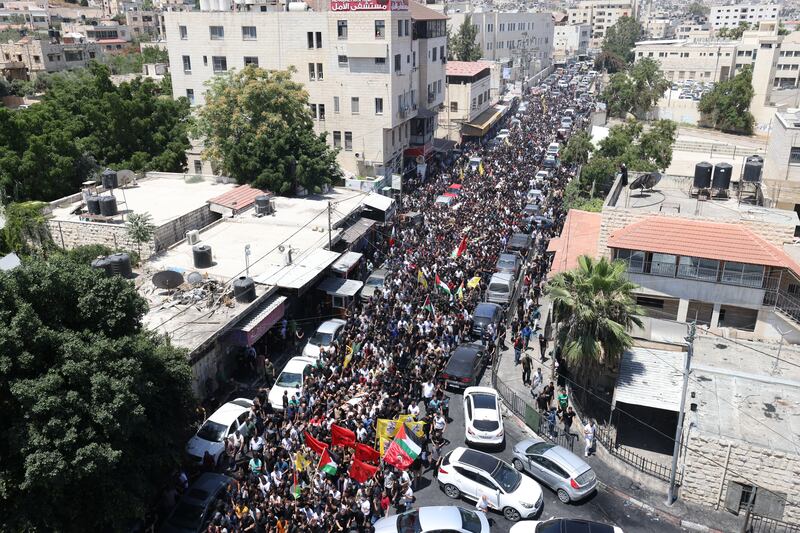 Hundreds of Palestinians join a funeral procession after 13 Palestinians were killed during an Israeli army raid in the occupied West Bank city of Jenin. EPA
