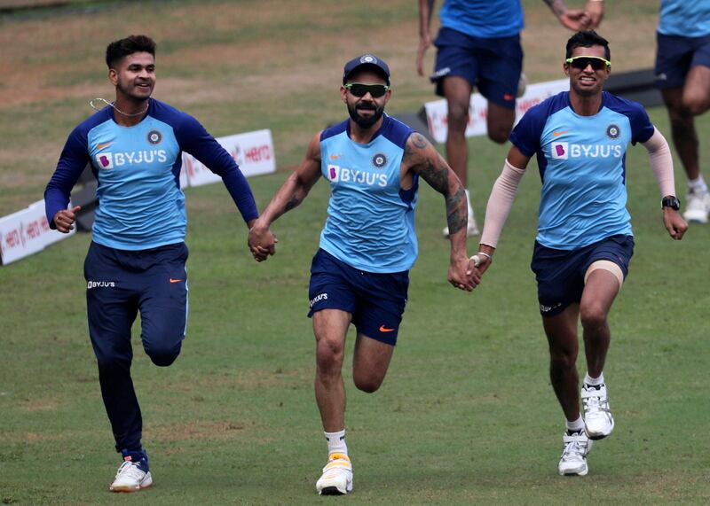 India's Shreyas Iyer, left, along with captain Virat Kohli, center, and Navdeep Saini attend a training session ahead of their first one-day international cricket match against Australia in Mumbai, India, Monday, Jan. 13, 2020. (AP Photo/Rafiq Maqbool)