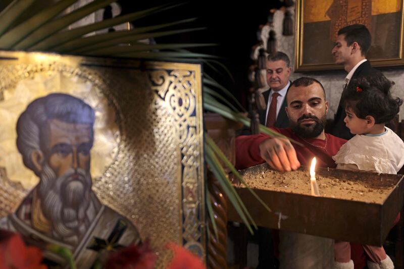 Palestinian Orthodox attend the Palm Sunday mass in Gaza City on Sunday. AFP