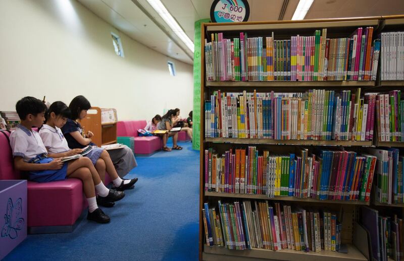 epa06826590 Children read books at a public library in Tseung Kwan O, Sai Kung District, New Territories, Hong Kong, 21 June 2018. The Hong Kong government has come under fire from gay rights activists in the city for removing from the shelves of all of its public libraries ten LGBTQ (Lesbian, Gay, Bisexual, Trans, Queer/Questioning) themed books for children, allegedly under pressure from Christian fundamentalist anti-gay rights groups. Due to a sudden surge in demand for the ten controversial books, none are available for borrowing from the 'closed stack' sections of Hong Kong libraries until 2019 at the earliest. 'Closed stacks' are storage sections in public libraries where library staff place books out of sight whilst off the shelves, but can these books can be retrieved by members of the public on demand.  EPA/ALEX HOFFORD