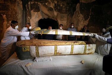 Archaeologists remove the cover of an intact sarcophagus inside the tomb TT33 in Luxor, Egypt November 24, 2018. Reuters