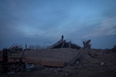 A man stands on a destroyed building on the outskirts of Baghouz, Syria, close to the frontline on February 10, 2019. Getty