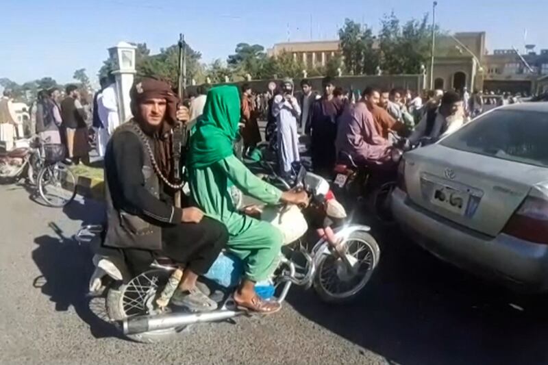 A Taliban fighter on the back of a motorcycle after the extremist group entered Herat.