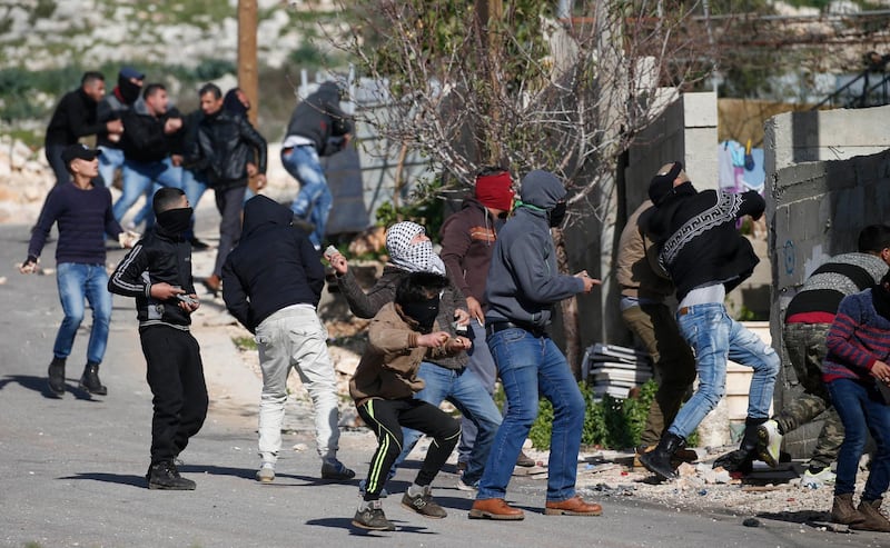 Palestinian protesters throw stones towards Israeli forces during clashes following a weekly demonstration against the expropriation of Palestinian lands by Israel in the village of Kfar Qaddum, near Nablus in the occupied West Bank. AFP