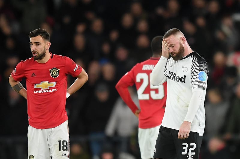 A dejected Wayne Rooney, right, after Manchester United scored their second goal in the FA Cup fifth-round tie against Derby County at Pride Park. Gettty