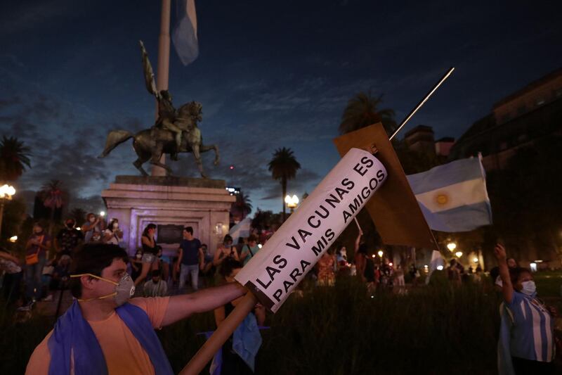 People protest against the government of President Alberto Fernandez, following a scandal over coronavirus vaccine queue-jumping that forced his health minister to resign, in front of the Casa Rosada presidencial palace in Buenos Aires.  AFP
