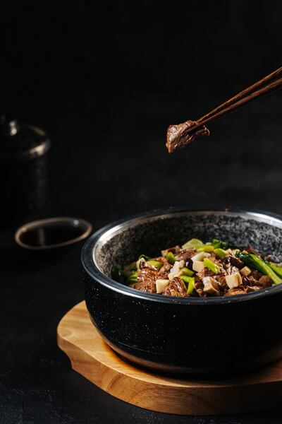 The rice is cooked in a stone pot with your choice of vegetables, meat or seafood. Photo: Shi