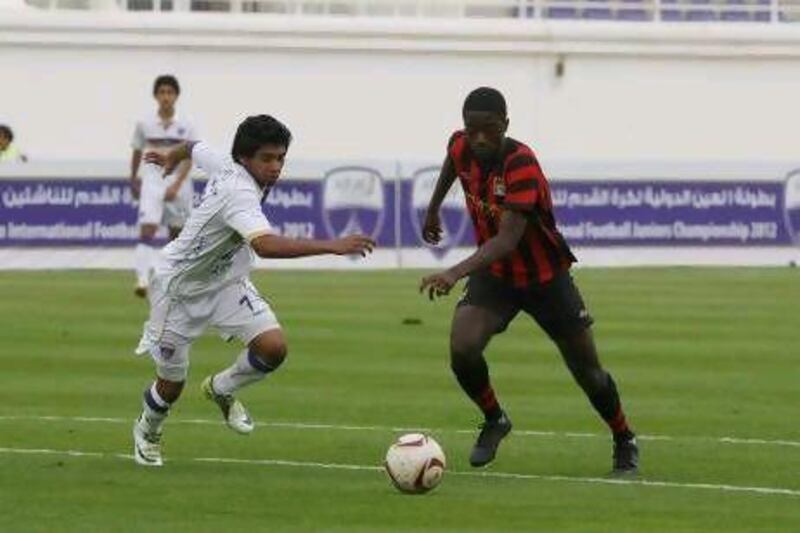 Al Ain, 10th April 2012. Jordy Mayifulia ( no 9 of Manchester City ) scores at this juncture against Ismail Hasan ( no 7 of Al Ain ), at the Al Ain International Football Junior Championship. ( Jeffrey E Biteng / The National )