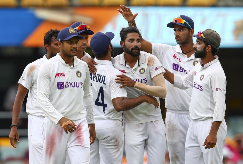 India's Mohammed Siraj, centre, is congratulated by teammates after taking his fifth wicket against Australia on Day 4 of the fourth Test at the Gabba on Monday, January 18. AP