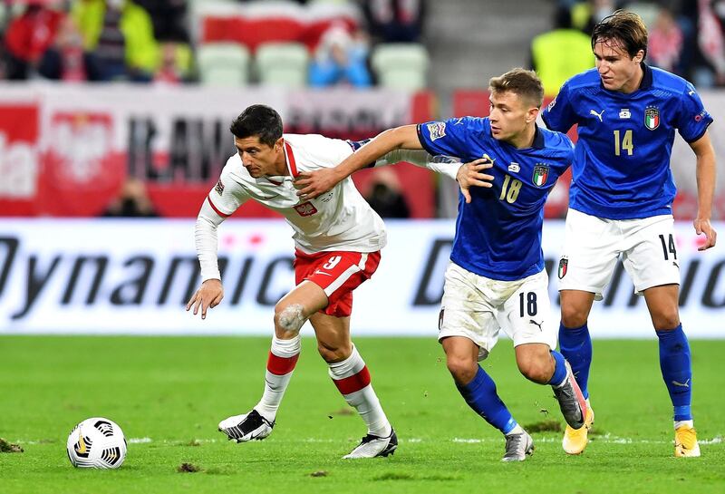 Robert Lewandowski, left, of Poland in action against Nicolo Barella, centre, and Federico Chiesa of Italy during the UEFA Nations League match in Gdansk, Poland. EPA