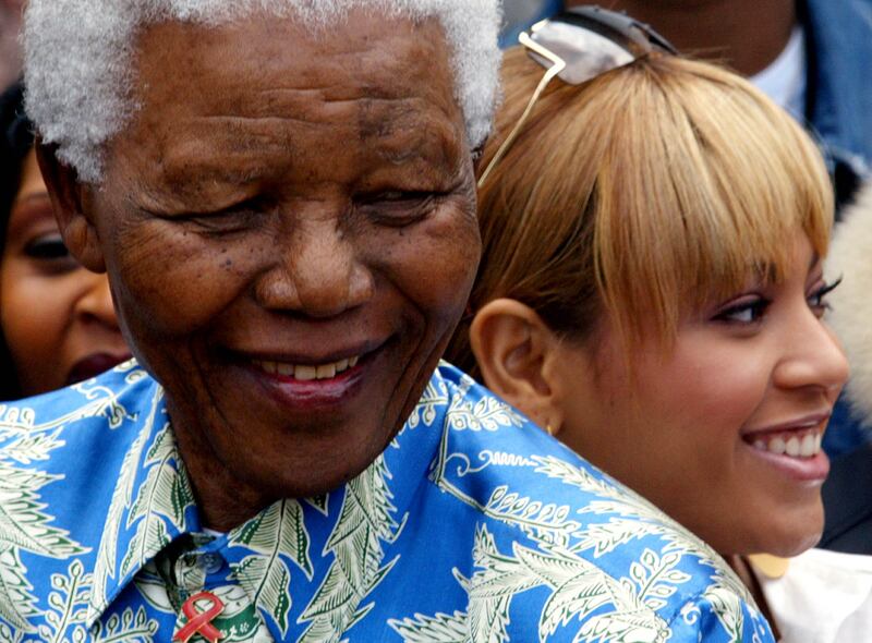 Nelson Mandela poses for photographers with Beyonce and other performers during a visit to Robben Island Prison near Cape Town, November 28, 2003. Reuters