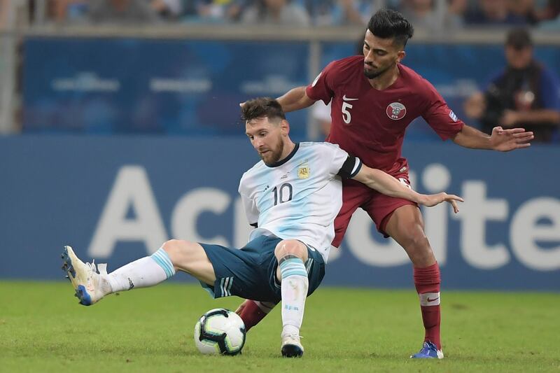Argentina's Lionel Messi is fouled by a Qatar player. EPA