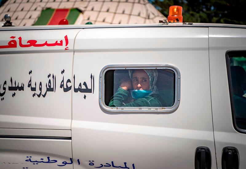 A Covid-19 patient arrives in a car park in the town of Moulay Bousselham, north of the capital Rabat, before being transferred to a medical centre in another city. AFP