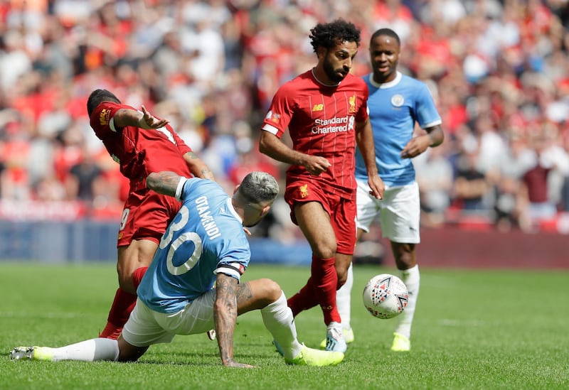 Liverpool's Mohamed Salah, right, challenges for the ball with Manchester City's Nicolas Otamendi. AP Photo